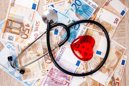 The Concept Of The Cost Of Medical Expenses. The Stethoscope And The Figure Of Heart On The Euro Banknotes