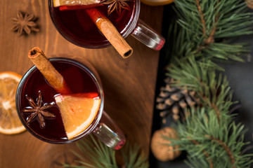 Christmas red wine mulled wine with fragrant spices and citrus fruits on a wooden table, close-up. Traditional hot drink for Christmas