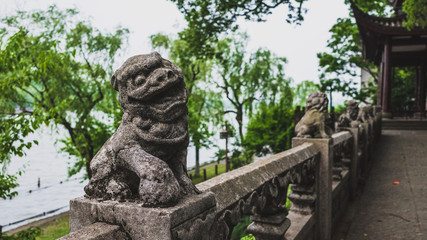 Fototapeta na wymiar Stone lion by West Lake, Hangzhou, China