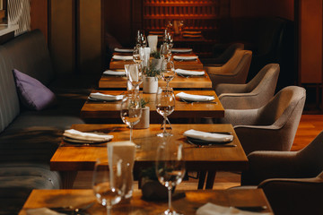 tableware Glasses, flower fork, knife served for dinner in restaurant with cozy interior