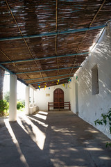 Entrance of abadoned church Ermita de Sant Antoni y Sant Jaume vertical in Cap Blanche, Altea, Spain