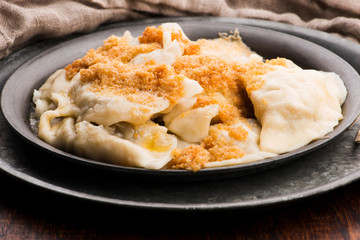 Boiled pierogi (Polish dumplings) stuffed with cabbage and mushrooms