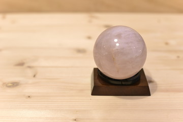 Rose Quartz Sphere on Wooden table