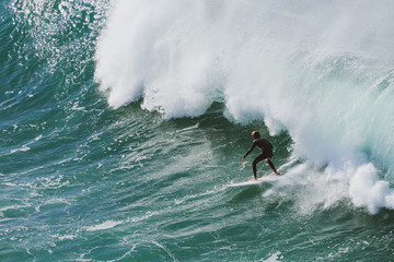 Surfer taking a big wave in Portugal