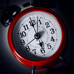 red alarm clock on dark background