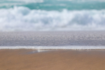 Wave with foam in a beach