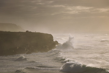 Naklejka na ściany i meble Seascape in a stormy day. Waves crash into the portuguese coastline