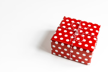 Valentine's day white background with  red gift box. Top view, layout, template, copy space. Minimal abstract composition for the celebration of February 14 and March 8.