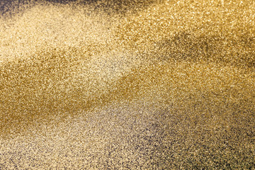 Golden glitter background for Christmas, new year, birthday, special occasions, with a copy space.