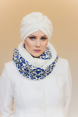 Photo of self assured Arabian lady in hijab, shows you right way, points at blank space with both...