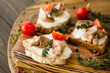 tasty snacks with cod liver with tomato