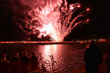 Fireworks to celebrate the arrival of Santa Claus by boat