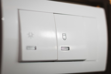 White water heater switch with icon on it, close up shot. Double switch control.