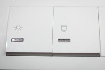 White double switch, controls light and water heater, close up shot