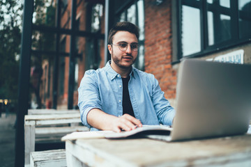 Busy freelancer using laptop and working with documents