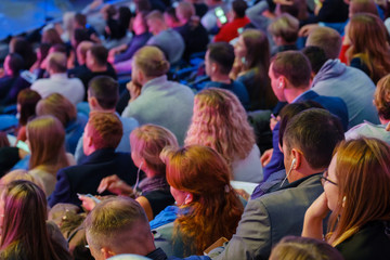 Business conference attendees sit and listen