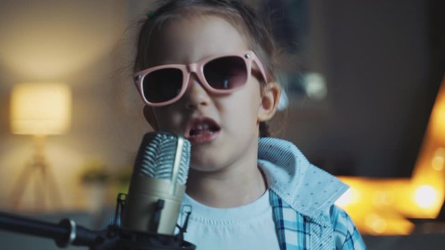 Little Girl Child Singing Song Into Microphone At Home