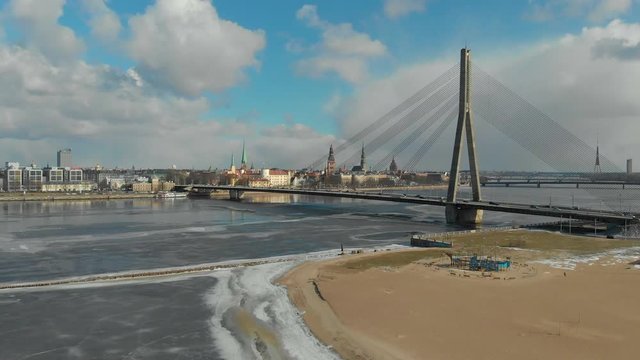 Riverside panorama of medieval European city of Riga in spring time, Bridge Vansu across river Daugava