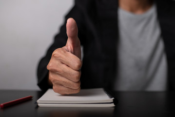 Businessman thumbs up sign satisfied with the work
