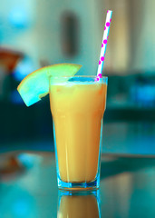 cocktail of pineapple, mango and passion fruit juice with ice on the table