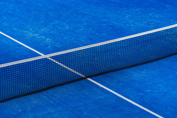 Blue paddle tennis net and court field background