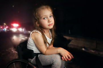 Fototapeta na wymiar Beautiful sad girl child disabled child sitting in a wheelchair. Victims of a car accident. Disabled children concept
