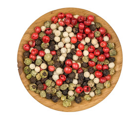 A mixture of peppers , in the plate isolated on white