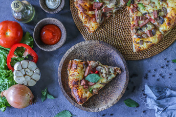 Photo of pizza on the table with ingredients around. Tasty pizza on the wooden background. Flat lay with top view. Italian pizza. Delicious pizza. Image