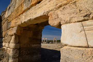 Ancient Roman columns with lintels seen through the stone block south gate at Hierapolis Turkey