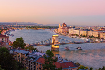 Naklejka na ściany i meble High perspective view of Budapest. Picturesque view of Chain Bridge over Danube River and The Hungarian Parliament Building in the background. Scenic autumn sunset colors. Budapest, Hungary