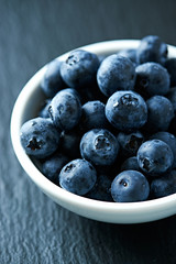Bilberries on dark stone background. Close up. 