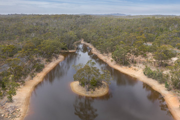 Aerial photograph of a drought affected water reservoir and mini island in rural Australia