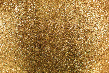 Golden sparkles glowing festive background with copy space.