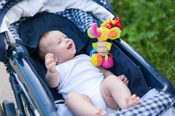 a small child in a stroller on a walk with mom and dad with parents