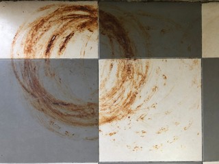 Rust stain on tile floor in home