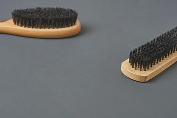 Two brushes with wooden handles for cleaning cloth, shoes, carpet or other textile product lies on...