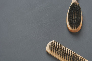 Two brushes with wooden handles for cleaning cloth, shoes, carpet or other textile product lies on...