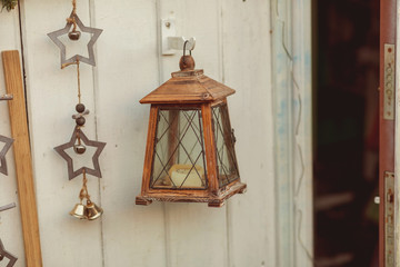 Wooden lantern and stars on a blue wall. Pendants.