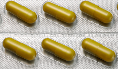 Brown capsules pill in blister pack arranged with beautiful pattern. Global healthcare concept. Antibiotics drug resistance. Antimicrobial capsule pills. Pharmaceutical industry. Pharmacy.