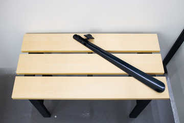 Wooden bench in the dressing room with shoehorn. Clothes fitting. Concept of clothing store. Retail...