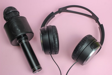 Vocal Bluetooth microphone and headphones on pink background