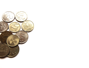 Several Russian coins lie on a white isolated background. Shiny Russian metal money. Place for text.