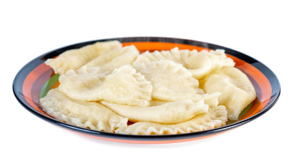Plate with boiled varenyky on white background.