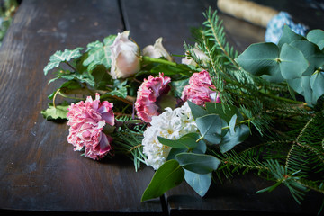 Close-up on the florist's table are flowers to form a bouquet to order, the concept of your own floristic salon