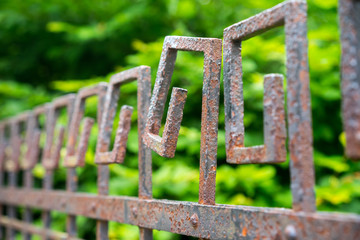 Closeup of rusty fence with spiral patterns