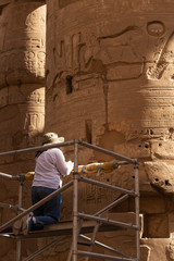 Karnak Temple, complex of Amun-Re. Embossed hieroglyphics on columns. Great Hypostyle Hall. A...