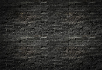 Black brick wall background. Old dark stone texture, Abstract surface black rough brick wall pattern. Vintage concrete, cement brickwork. Blank copy space for design backdrop.