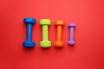 Different dumbbells on color background