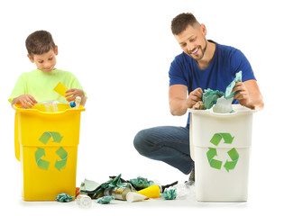 Father and son with containers for garbage on white background. Concept of recycling