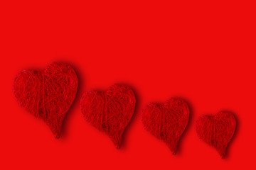hearts of different sizes on a red background. Concept of St. Valentine's Day